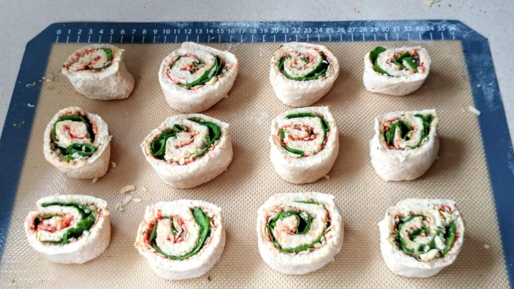 Two-Ingredient Dough4 with filling on baking tray rolled up into scrolls - The Simple Healthy Hub