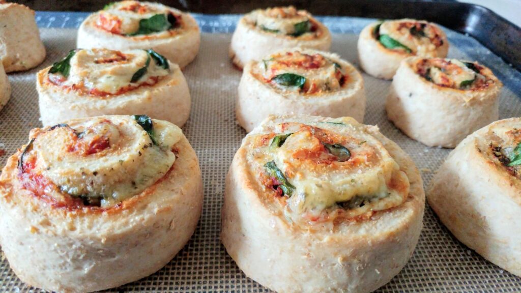 Vegetarian Pizza Scrolls baked on a baking tray - The Simple Healthy Hub